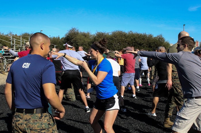 Educators participate during a Marine Corps Martial Arts Program event at Marine Corps Recruit Depot San Diego, Calif., during the Recruiting Station St. Louis Educators Workshop, March 5-9. The purpose of the workshop is to identify and provide selected educators and other community influencers the opportunity to gain first-hand experience on how the Marine Corps transforms young men and women into U.S. Marines. This workshop provides current information regarding  Marine Corps recruit training practices and procedures, military job skills and opportunities, military lifestyle, and educational benefits available to Marines. The intent of the program is to demystify the recruit training experience and foster closer relationships between recruiting station personnel and those in their communities who have influence on the decisions of young men and women.