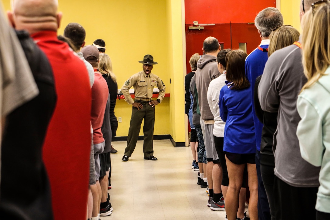 A drill instructor speaks to educators at Marine Corps Recruit Depot San Diego, Calif., during the Recruiting Station St. Louis Educators Workshop, March 5-9. The purpose of the workshop is to identify and provide selected educators and other community influencers the opportunity to gain first-hand experience on how the Marine Corps transforms young men and women into U.S. Marines. This workshop provides current information regarding  Marine Corps recruit training practices and procedures, military job skills and opportunities, military lifestyle, and educational benefits available to Marines. The intent of the program is to demystify the recruit training experience and foster closer relationships between recruiting station personnel and those in their communities who have influence on the decisions of young men and women.