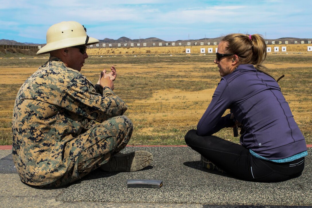 A Marine marksmanship coach gives rifle handling basics to an educator at Edson Range at Marine Corps Base Camp Pendleton, Calif., during the Recruiting Station St. Louis Educators Workshop, March 5-9. The purpose of the workshop is to identify and provide selected educators and other community influencers the opportunity to gain first-hand experience on how the Marine Corps transforms young men and women into U.S. Marines. This workshop provides current information regarding  Marine Corps recruit training practices and procedures, military job skills and opportunities, military lifestyle, and educational benefits available to Marines. The intent of the program is to demystify the recruit training experience and foster closer relationships between recruiting station personnel and those in their communities who have influence on the decisions of young men and women.