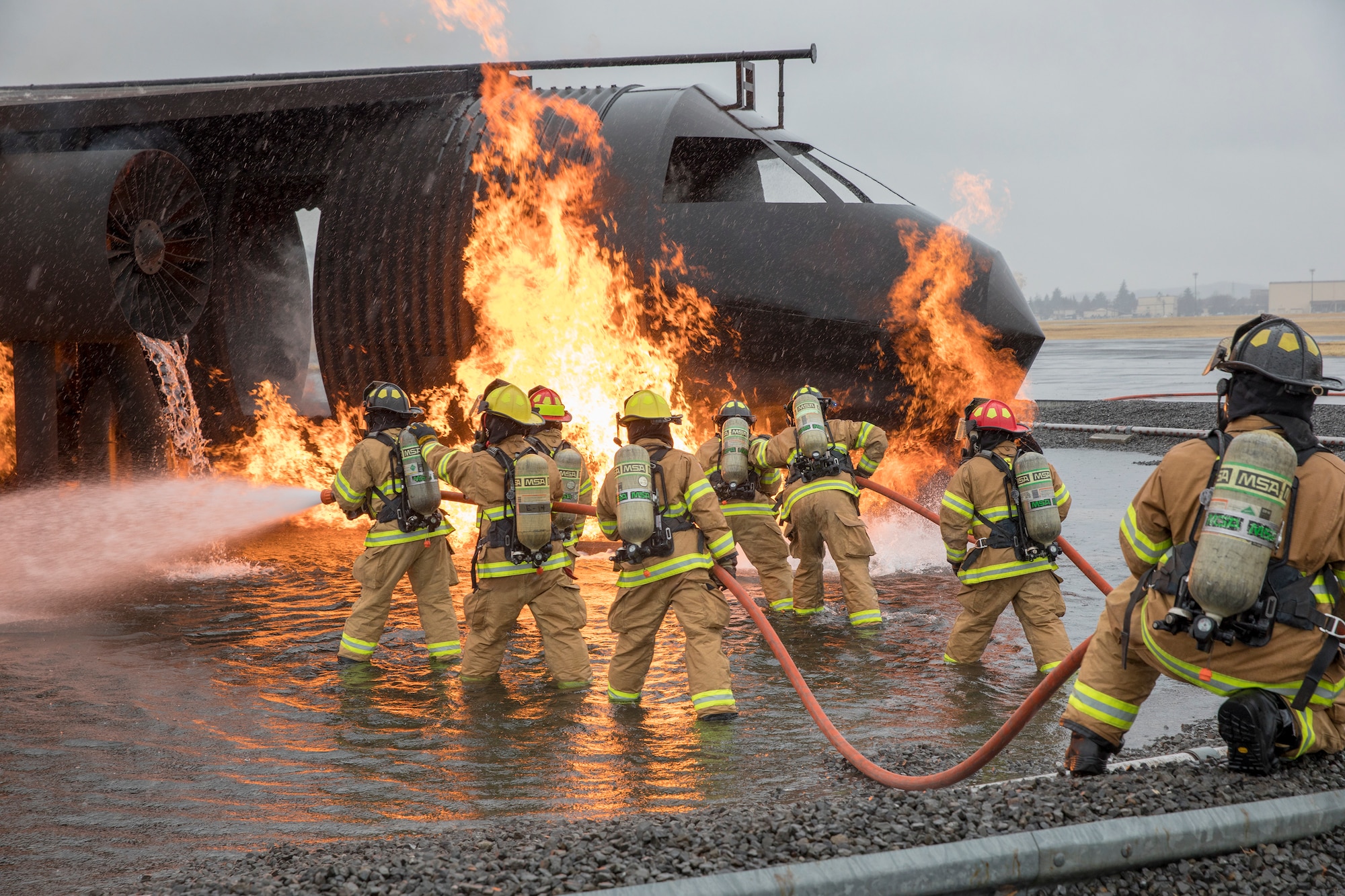Firefighters with the 374th Civil Engineer Squadron battle a simulated aircraft fire at Yokota Air Base