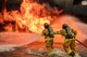 A two-person fire attack crew with the 374th Civil Engineer Squadron fire and emergency services flight, aim a stream of water on a simulated aircraft fire at Yokota Air Base, Japan