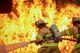 A two-person fire attack crew with the 374th Civil Engineer Squadron fire and emergency services flight aim a stream of water on a simulated aircraft fire at Yokota Air Base