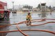 Staff Sgt. Trevor Alexis, 374th Civil Engineer Squadron firefighter, straightens out a hose after battling a simulated aircraft fire at Yokota Air Base