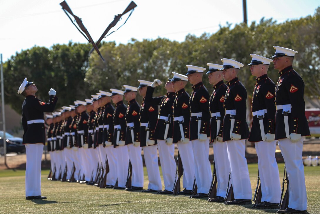 Marines on the rifle inspection team with the U.S. Marine Corps Silent Drill Platoon executes the rifle inspection sequence during a dress rehearsal of the Battle Color ceremony at Marine Corps Air Station Yuma, Yuma, Az., March 2, 2018. This dress rehearsal marks the end of the Marines’ month-long training phase in Yuma. The Marines will move on to display their hard work and dedication during their performances on the West Coast Tour and throughout the 2018 parade season. (Official Marine Corps photo by Cpl. Damon Mclean/Released)