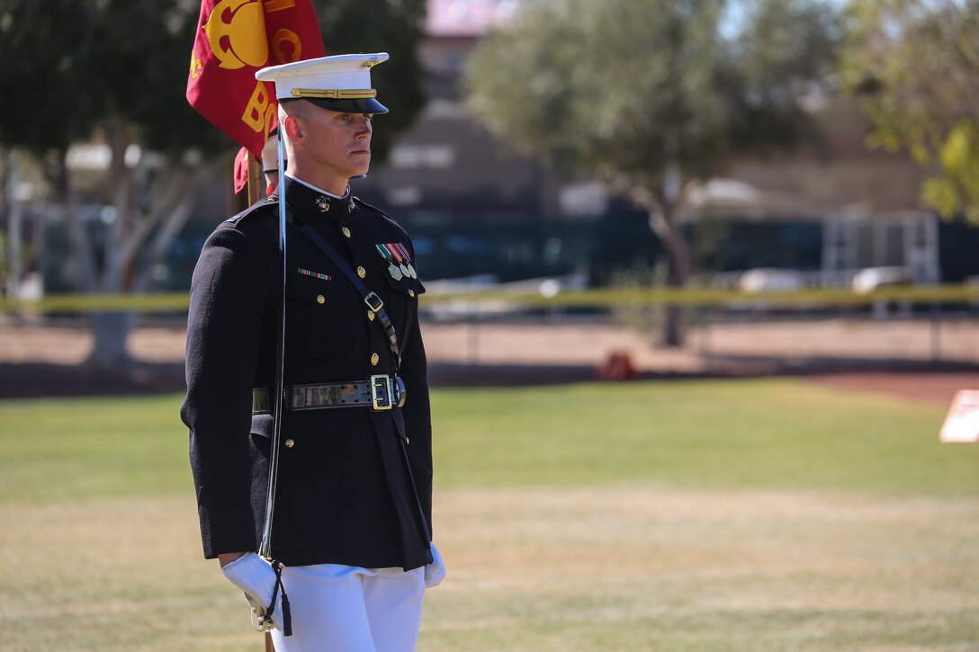 Captain Matthew S. Galadyk, platoon commander, U.S. Marine Corps Silent Drill Platoon, marches alongside the guideon bearer during a dress rehearsal of the Battle Color ceremony at Marine Corps Air Station Yuma, Yuma, Az., March 2, 2018. This dress rehearsal marks the end of the Marines’ month-long training phase in Yuma. The Marines will move on to display their hard work and dedication during their performances on the West Coast Tour and throughout the 2018 parade season. (Official Marine Corps photo by Cpl. Damon Mclean/Released)
