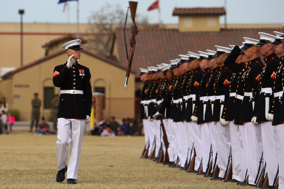 Corporal Ryan Watkins, rifle inspector, U.S. Marine Corps Silent Drill Platoon, prepares to catch a rifle during the first West Coast tour performance at Marine Corps Air Station Yuma, Yuma, Az., March 7, 2018. Col. David A. Suggs, commanding officer, MCAS Yuma, was the hosting official and spoke to the Marines of the BCD after the performance. (Official Marine Corps photo by Cpl. Damon Mclean/Released)