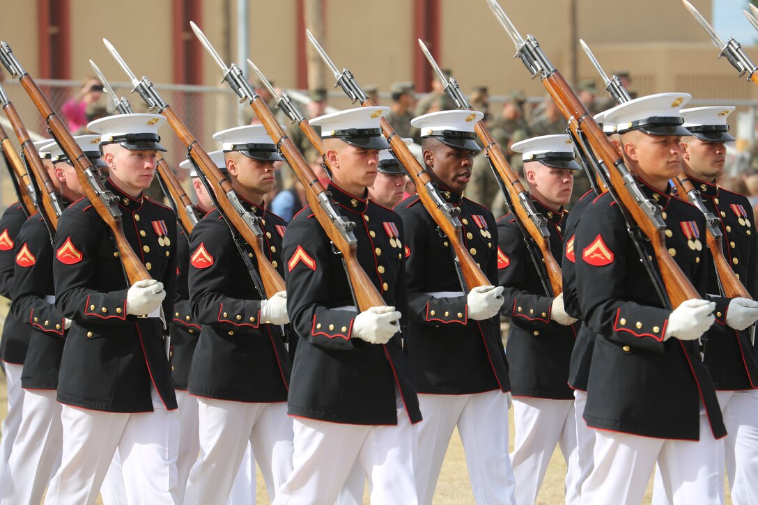 Marines with the U.S. Marine Corps Silent Drill Platoon march off the parade deck at the conclusion of the first West Coast tour performance at Marine Corps Air Station Yuma, Yuma, Az., March 7, 2018. Col. David A. Suggs, commanding officer, MCAS Yuma, was the hosting official and spoke to the Marines of the BCD after the performance.(Official Marine Corps photo by Cpl. Damon Mclean/Released)