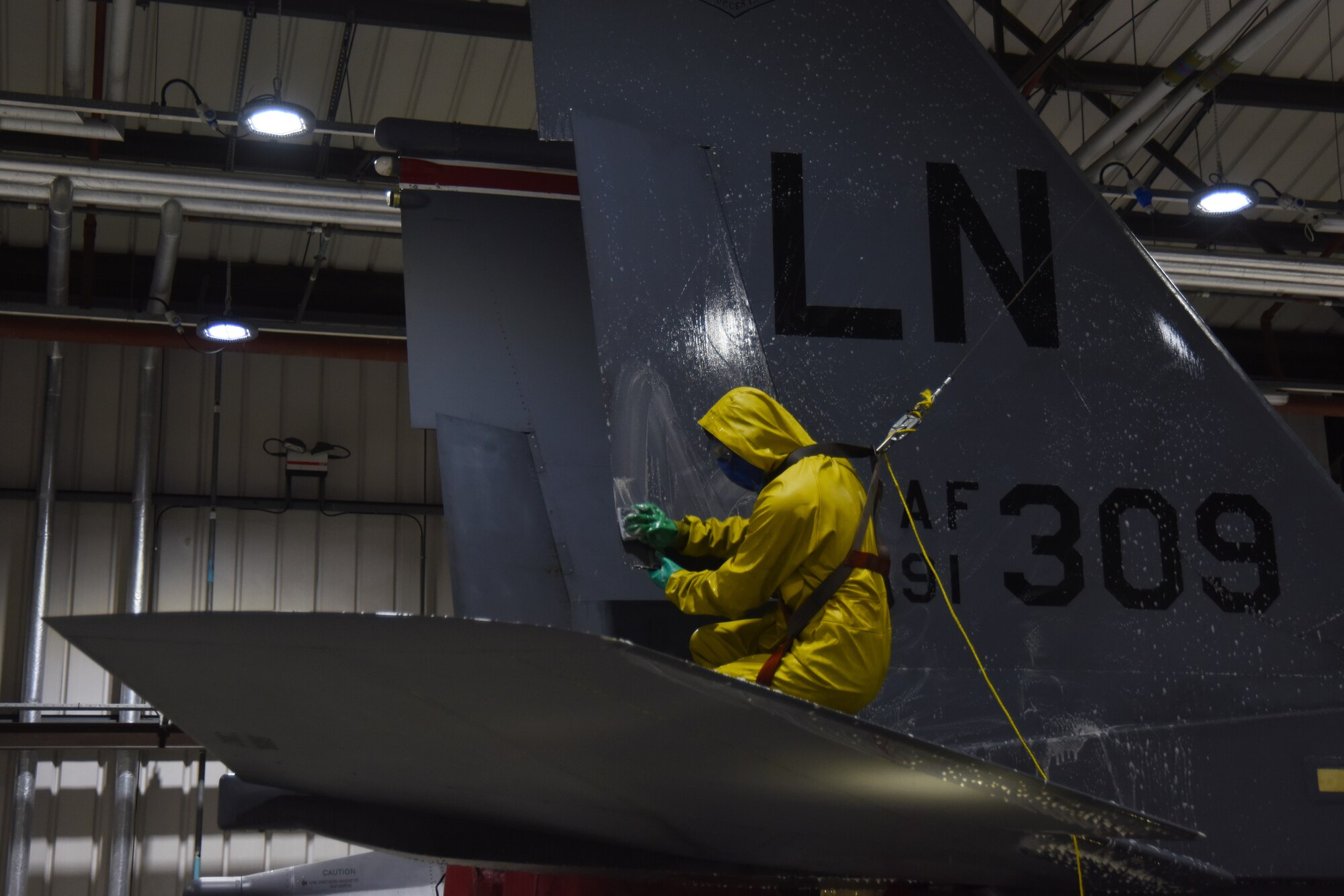 A 494th Aircraft Maintenance Unit crew chief washes a 494th Fighter Squadron F-15E Strike Eagle at Royal Air Force Lakenheath, England, March 13. After the aircraft is washed, the paint is inspected to make sure there are no areas that need to be touched up. The paint helps seal the metal and prevent corrosion. (U.S. Air Force photo/Senior Airman Abby L. Finkel)
