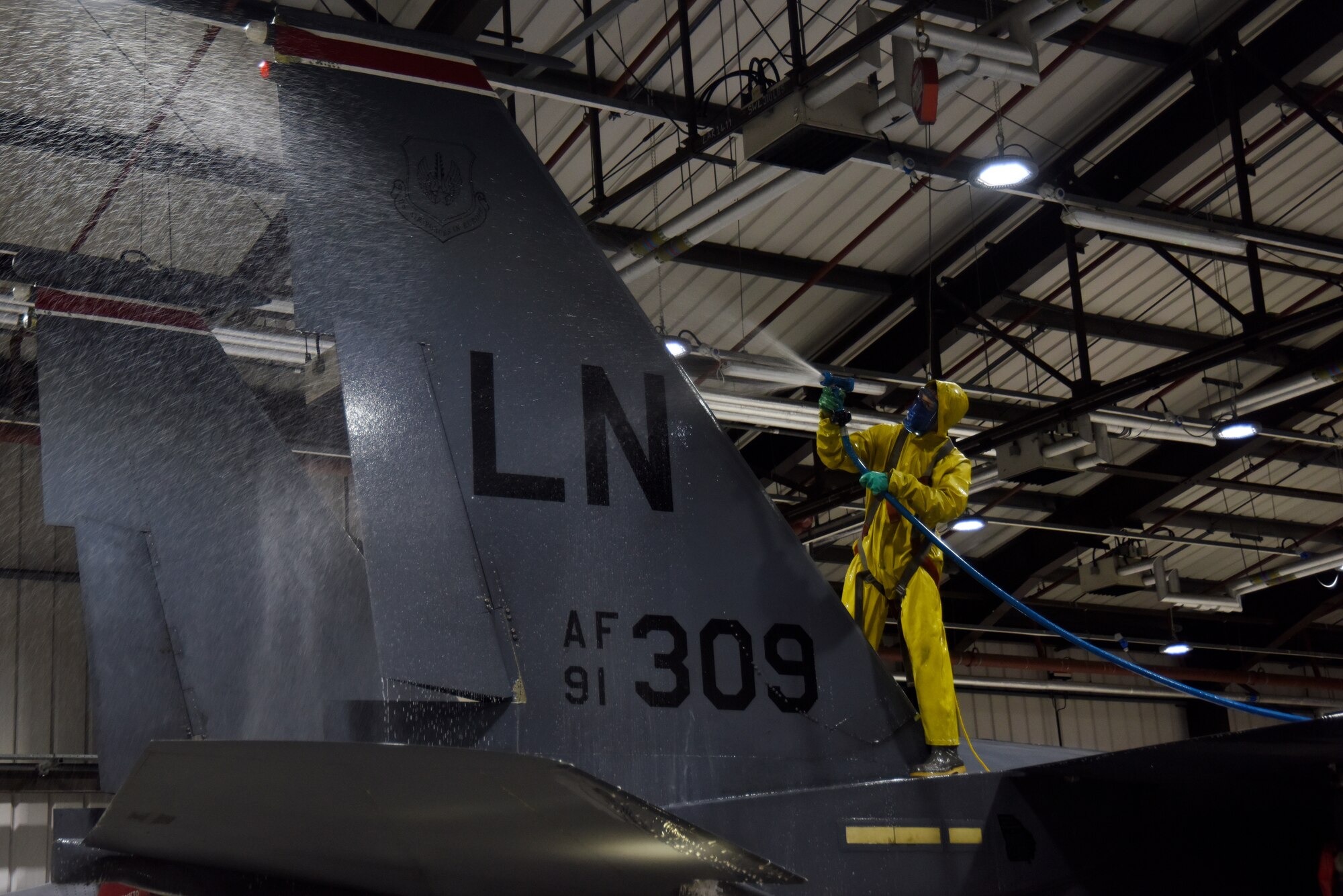 A 494th Aircraft Maintenance Unit crew chief sprays water on a 494th Fighter Squadron F-15E Strike Eagle at Royal Air Force Lakenheath, England, March 13. All Liberty Wing F-15s are washed regularly to keep them in top shape and able to provide worldwide responsive airpower and support. (U.S. Air Force photo/Senior Airman Abby L. Finkel)