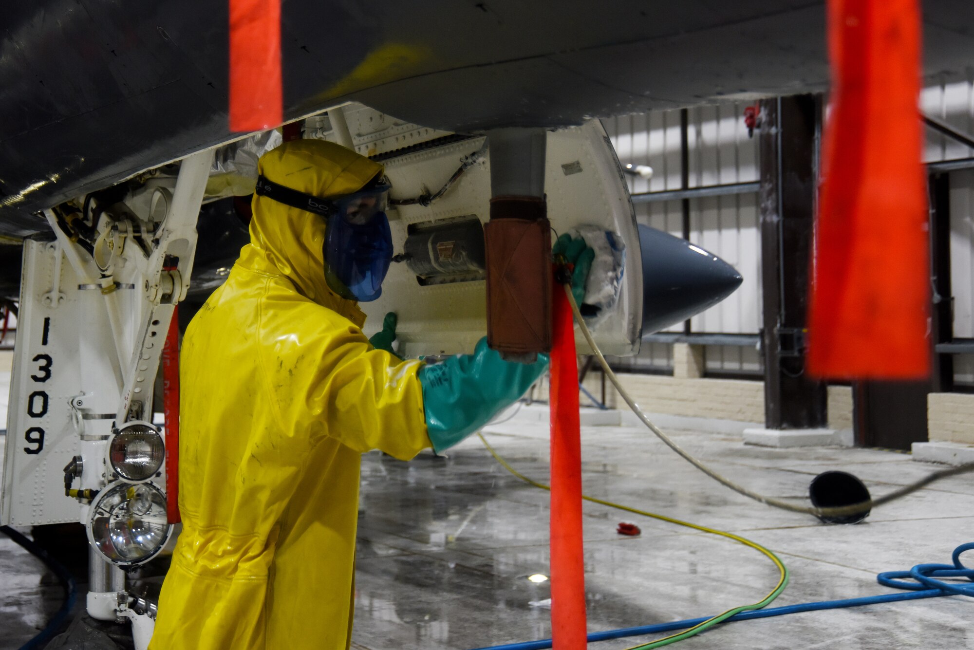 A 494th Aircraft Maintenance Unit crew chief scrubs a 494th Fighter Squadron F-15E Strike Eagle at Royal Air Force Lakenheath, England, March 13. Crew chiefs and Airmen from several career fields wash all Liberty Wing F-15s to rid them of any sand, dirt, salt or other corrosive materials that may have accumulated during flying operations. (U.S. Air Force photo/Senior Airman Abby L. Finkel)