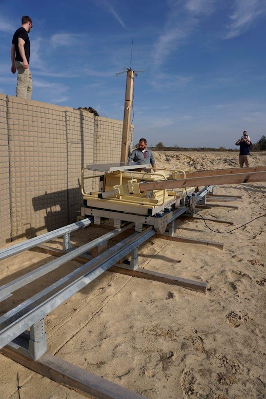 A man inspects large equipment on tracks