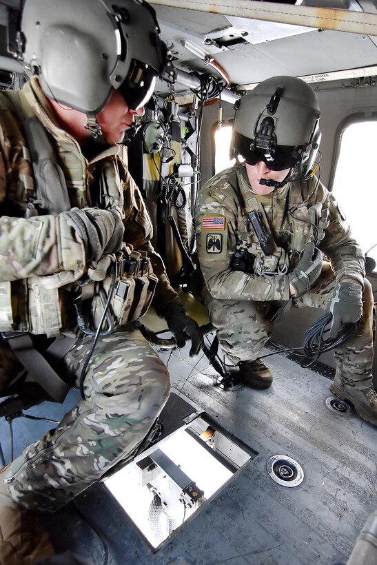Army crew chiefs keep an eye on ammunition being sling-load.
