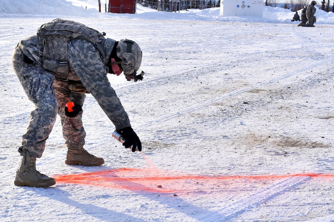 A soldier marks the landing area.