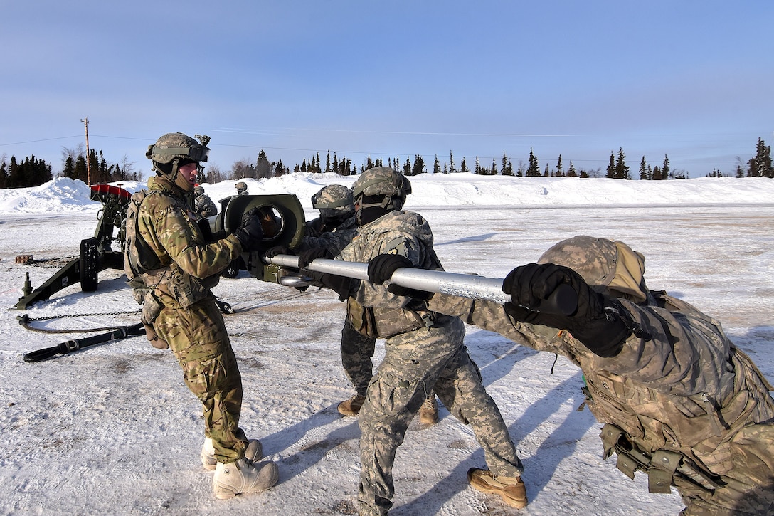 Soldiers move a 155mm howitzer to the proper firing position.