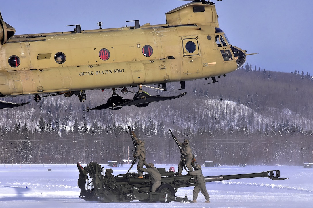 Soldiers prepare to transport a 155 mm howitzer.