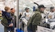 Col. Ethan Griffin, 436th Airlift Wing commander, and his son Paxton, stop by the Dover Eagles bench before the start of a charity hockey game, March 10, 2018, at the Centre Ice Rink in Harrington, Del. The Dover Eagles won the game against the Dover Fraternal Order of Police Lodge 15, 8-4. (U.S. Air Force photo by Roland Balik)