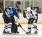 Dover Eagles center Sam Ernst (21), right and Dover Fraternal Order of Police Lodge 15 forward Steven Schultz (12) face off during a charity hockey game March 10, 2018, at the Centre Ice Rink in Harrington, Del. The Dover Eagles hockey team is comprised of current and former members of Team Dover, military retirees and veterans. (U.S. Air Force photo by Roland Balik)