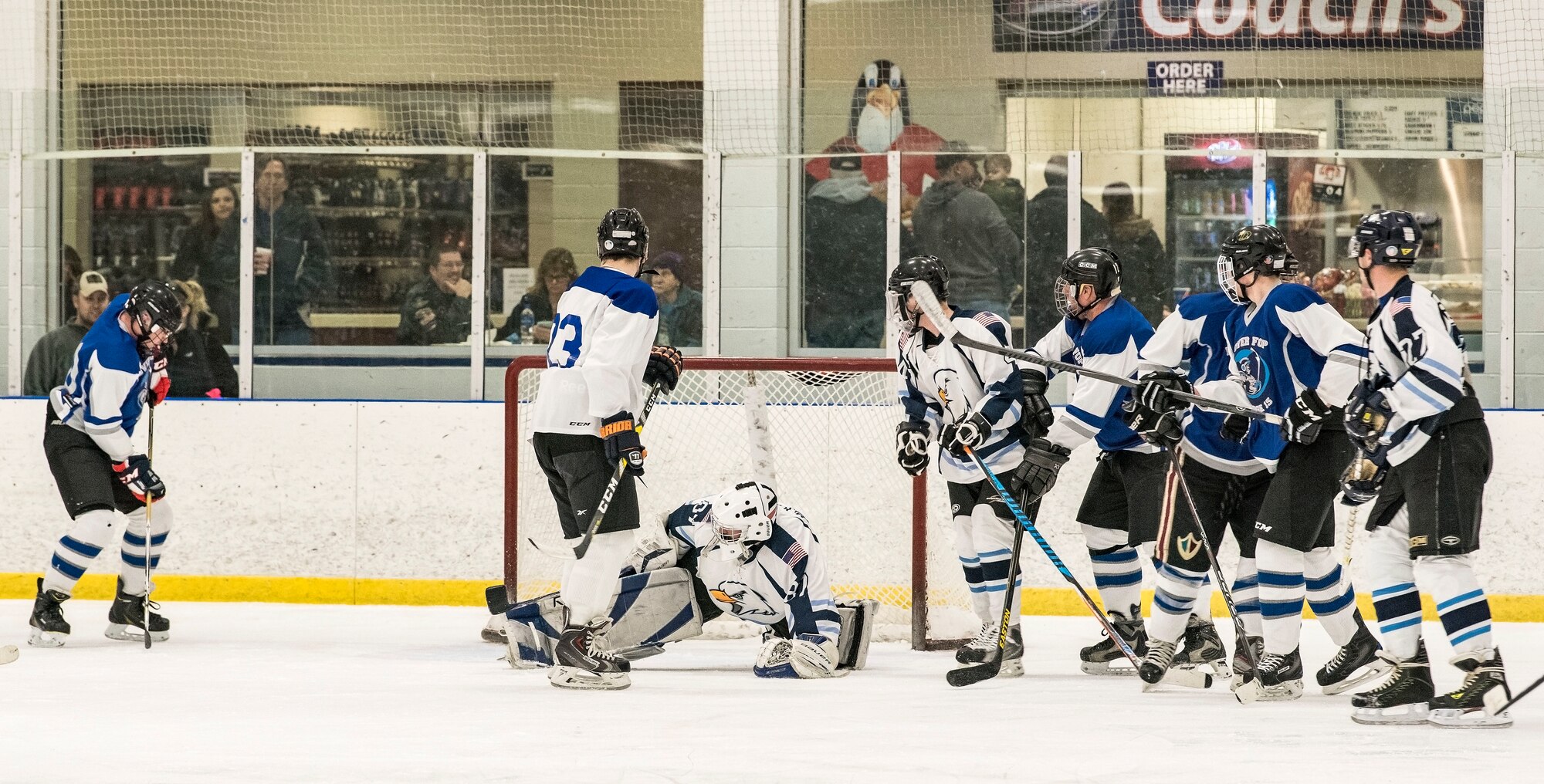 Dover Eagles goaltender Matthew McKenzie (87) blocks a shot by a Dover Fraternal Order of Police Lodge 15 player near the end of the second period during a charity game March 10, 2018, at the Centre Ice Rink in Harrington, Del. The Eagles scored two goals within the first couple of minutes and went on to win the game 8-4. (U.S. Air Force photo by Roland Balik)