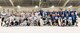 The Dover Eagles and Dover Fraternal Order of Police Lodge 15 hockey teams pose for a group photo after a charity hockey game March 10, 2018, at the Centre Ice Rink in Harrington, Del. The proceeds of the game went to the families of Correctional Officer Lt. Steven Floyd, who was killed in the line of duty, and Dover Police Department officer Cpl. Thomas Hannon, who passed away due to medical complications he suffered from a line of duty injury. (U.S. Air Force photo by Roland Balik)