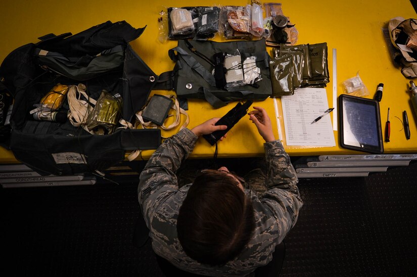 U.S. Air Force Senior Airmen Brittany Cup Choy, 20th Operations Support Squadron aircrew flight equipment journeyman, packs an ACES II ejection seat survival kit at Shaw Air Force Base, S.C., March 7, 2018.