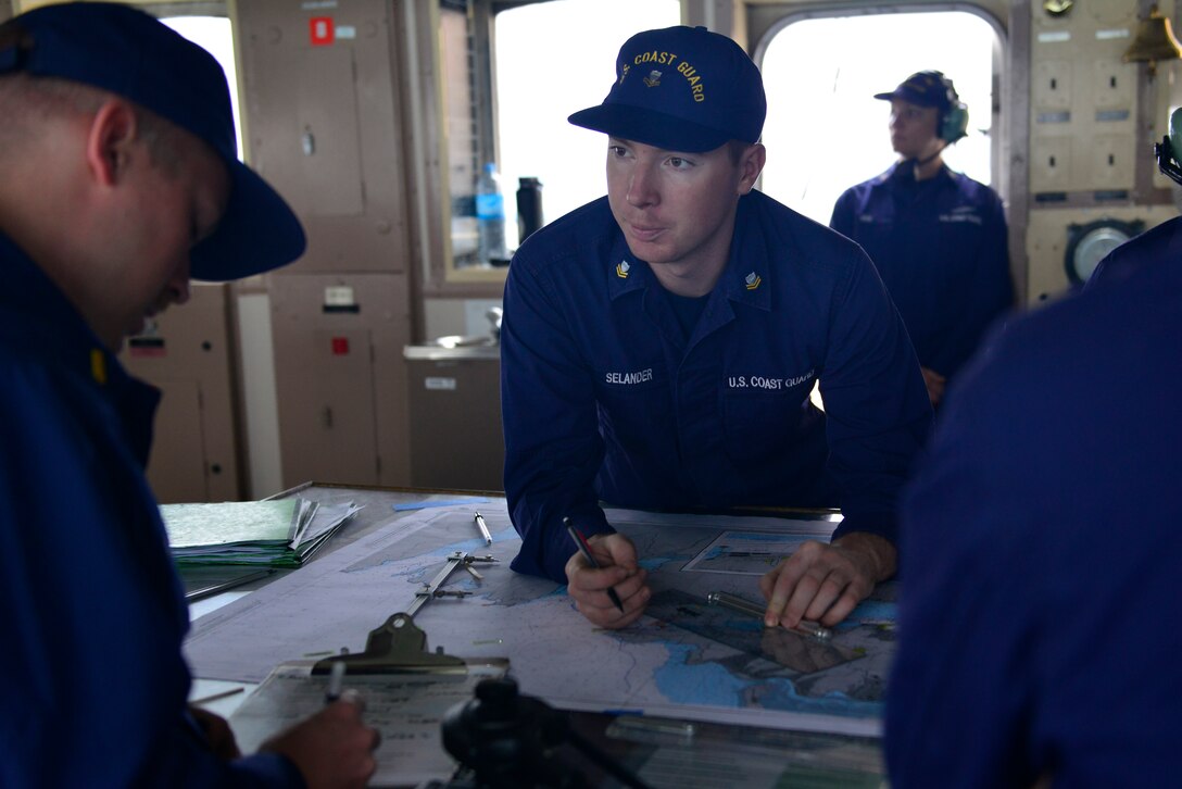 Petty Officer 2nd Class Nils Selander, a boatswain’s mate aboard the Coast Guard Cutter Polar Star, stands watch on the ship’s bridge as it transits out of Lyttelton, New Zealand, Wednesday, Jan. 3, 2018.