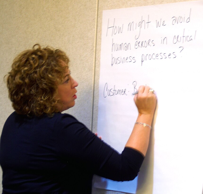 Teresa Smith, DLA Information Operations chief data officer, writes down ideas for her group during the DLA Information Operations senior leader innovation boot camp.