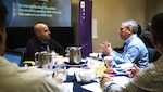 Craig Gravitz, left, of the DLA Information Operations innovation team, discusses a problem statement with Bob Dunlap, director of DLA Cybersecurity Operations, at the DLA Information Operations senior leader innovation boot camp in Springfield, Virginia.