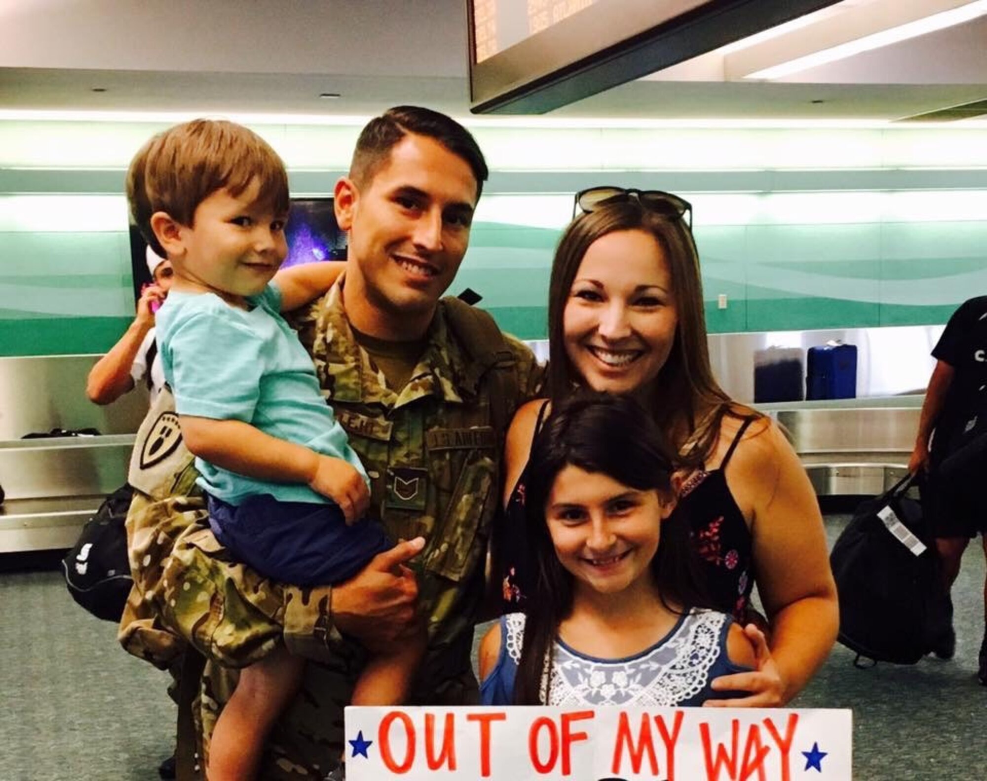 U.S. Air Force Tech. Sgt. Michael Vallejo, an explosive ordnance disposal team leader from the 509th Civil Engineer Squadron, poses with his wife Laura, and his children Brayden and Mylie after returning from a deployment.