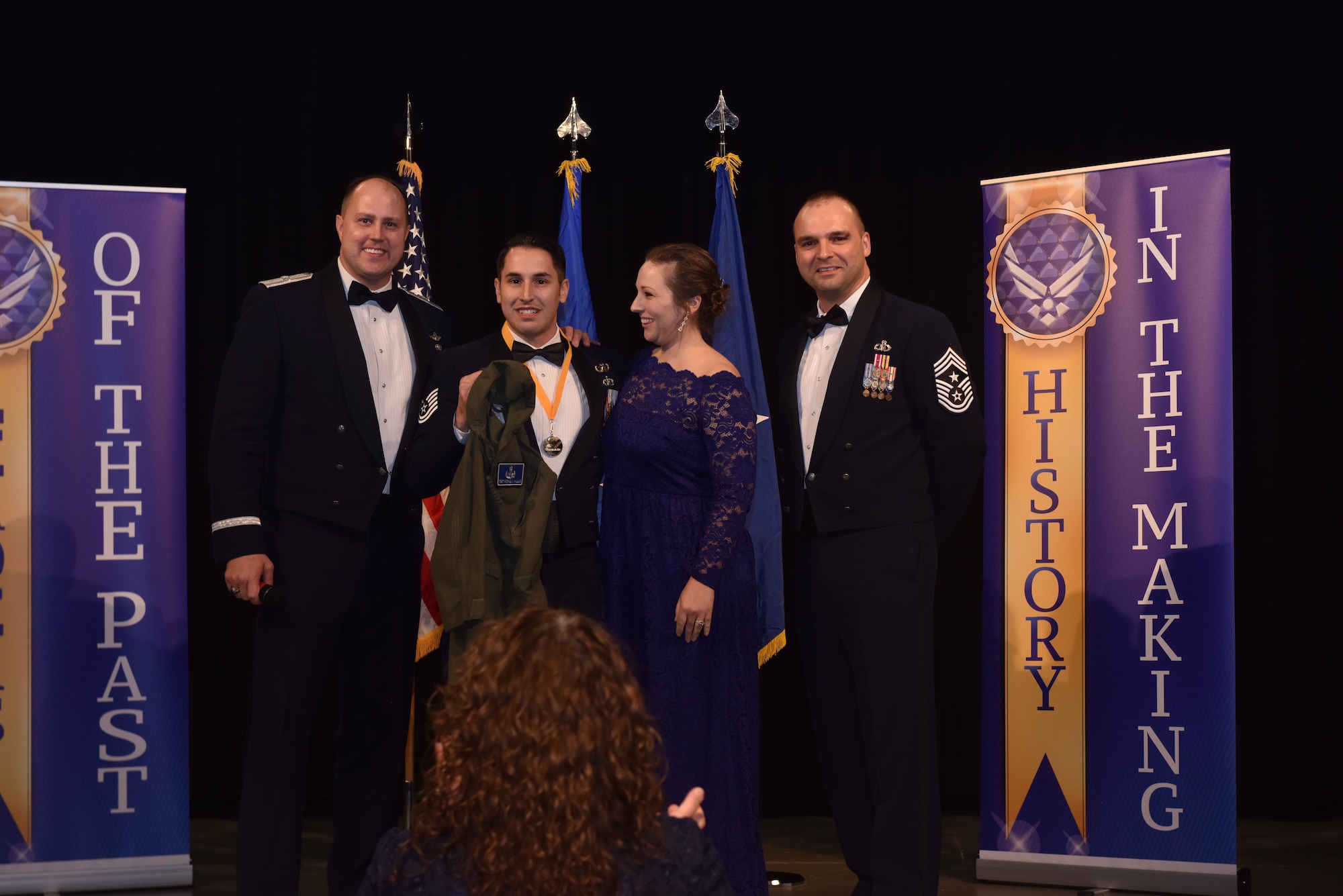 Tech. Sgt. Michael Vallejo, a 509th Civil Engineer Squadron explosive ordnance disposal team leader, receives a personalized flight suit from Brig. Gen. John Nichols, the 509th Bomb Wing commander, and Chief Master Sgt. James Lyda, the 509th BW command chief, during the 2017 Annual Awards Banquet at Whiteman Air Force Base, Mo., March 2, 2018.