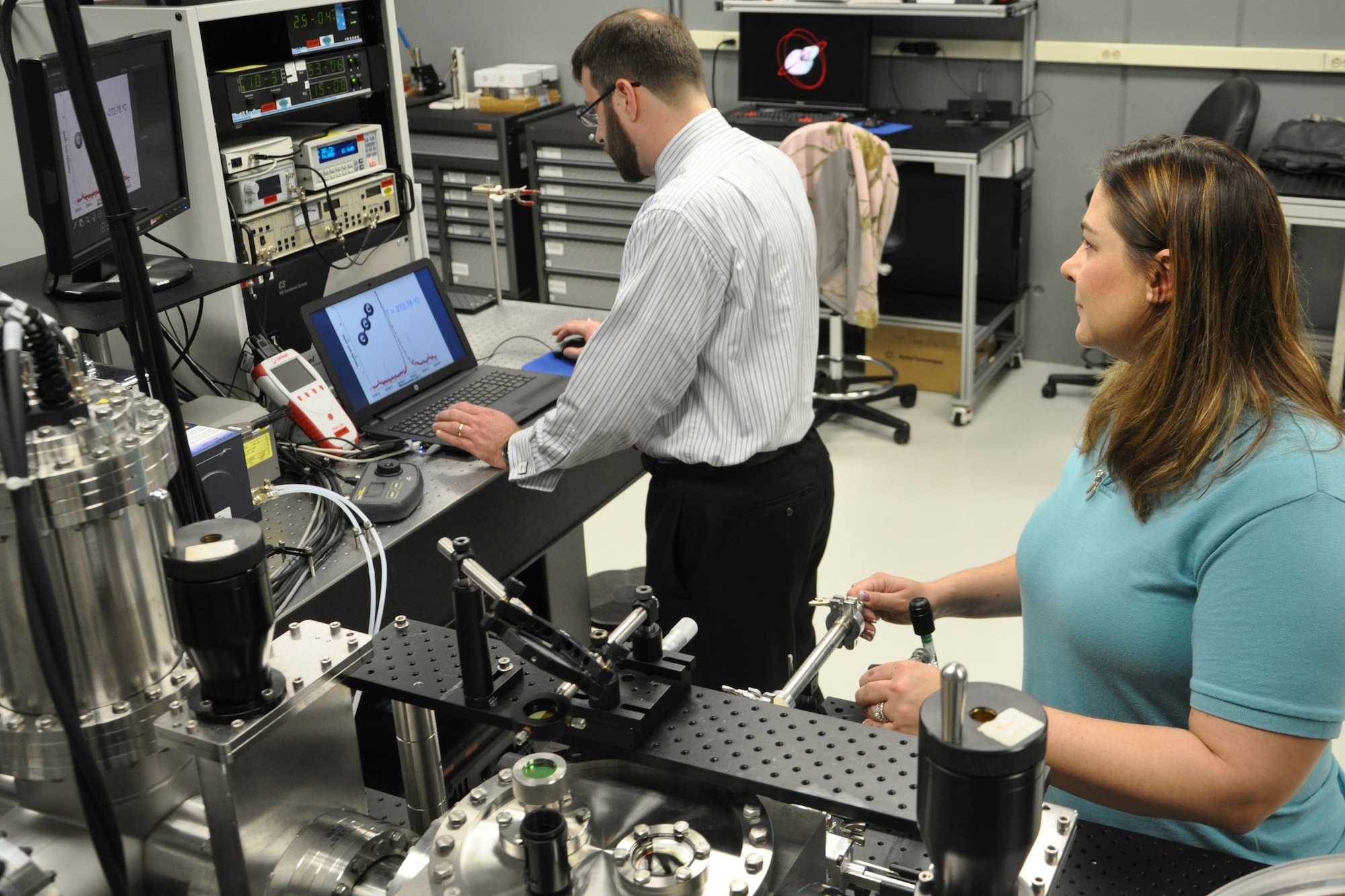 Dr. William Lewis, AFRL Senior Research Chemist with the Turbine Engine Division, Aerospace Systems Directorate, and Barbara Miller, University of Dayton Research Institute Research Chemist and UDRI Team lead contractor, record the infrared spectrum of the C3 molecules at a temperature of -272.78 degrees Celsius in the Cluster Assembly and Spectroscopy Instrument. The super low temperature spectrum allows them to clearly determine the structure and bonding in the C3 molecule. (U.S. Air Force Photo/Staff Sgt. Ashley Clingerman)