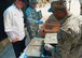 An evaluator from the National Restaurant Association checks for proper food temperature controls inside a 919th Special Operations Force Support Squadron single-pallet expeditionary kitchen at Duke Field, Fla