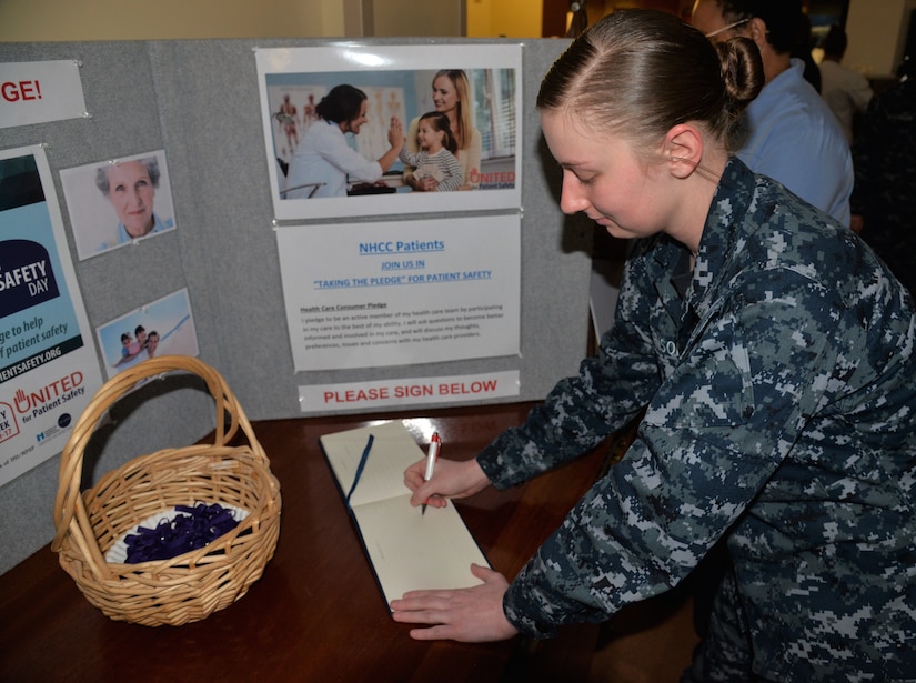 Seaman Crystal Johnson, a hospital corpsman serving at Naval Health Clinic Charleston, signs the Patient Safety Pledge during a ceremony March 12, kicking off Patient Safety Week, which runs March 11-17, at NHCC.