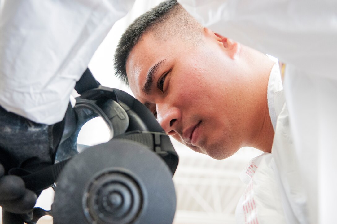Senior Airman Nicklaus Young an aerospace medical technician with the  Detachment 1, 154th Medical Group, dons his gas mask at a Medical Capabilities exercise held in North Las Vegas, Jan. 27, 2018.