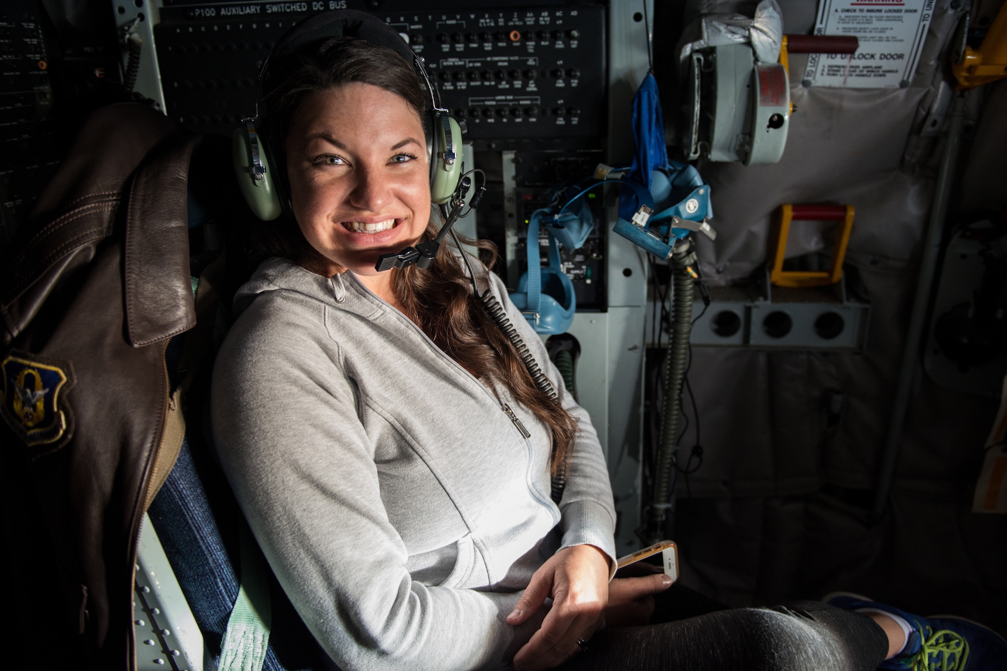 A military spouse from Luke Air Force Base poses for a photo during a spouse orientation flight over Arizona, March 12, 2018. Luke AFB provided military spouses the opportunity to ride in a KC-135 Stratotanker to spectate an in-flight refueling mission. (U.S Air Force photo/Airman 1st Class Alexander Cook)