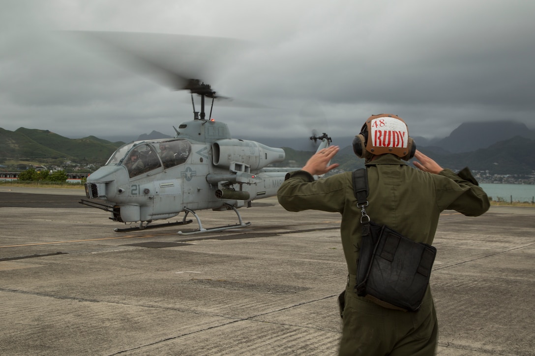 U.S. Marine Cpl. Austin Rudesill taxies an AH-1W Super Cobra helicopter off of a flight line on Marine Corps Base Hawaii, March 13, 2018. The AH-1Ws were flown for the last time on Hawaii to retire from Marine Light Attack Helicopter Squadron 367. Rudesill, a native of Rosemount, Minnesota, is a plane captain with HMLA-367, Marine Aircraft Group 24. (U.S. Marine Corps photo by Sgt. Kathy Nunez)