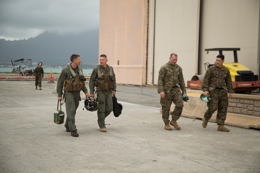 U.S. Marine Lt. Col. Frank Makoski and Maj. Robert Arbegast walk off of the flight line on Marine Corps Base Hawaii, March 13, 2018. The Marines completed their final flight with the AH-1W Super Cobra helicopters before the aircraft retire from Marine Light Attack Helicopter Squadron 367. Makoski, an Orwell, Ohio native, is the commanding officer of HMLA-367, Marine Aircraft Group 24. Arbegast, an Ayden, North Carolina native, is the maintenance officer of HMLA-367, MAG-24. (U.S. Marine Corps photo by Sgt. Kathy Nunez)