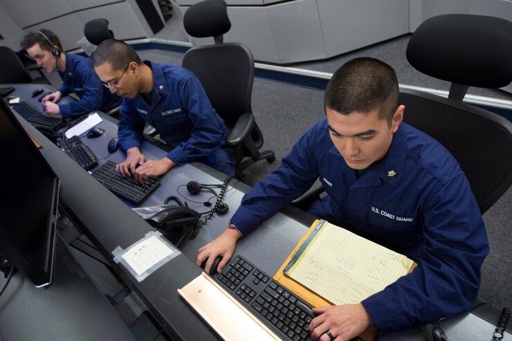 A Coast Guard Information Systems Technician adjusts cables inside a server room at the Telecommunication and Information Systems Command (TISCOM) Jan. 24, 2013.