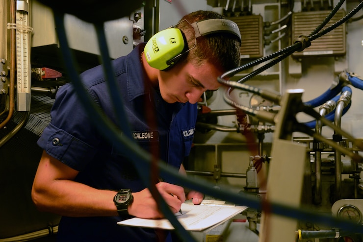 Seaman Antonio Brancaleone, a crew member aboard the Coast Guard Cutter Flyingfish, homeported in Boston, conducts a round of the cutter’s engine room while underway in Boston Harbor Friday, Sept. 11, 2015.