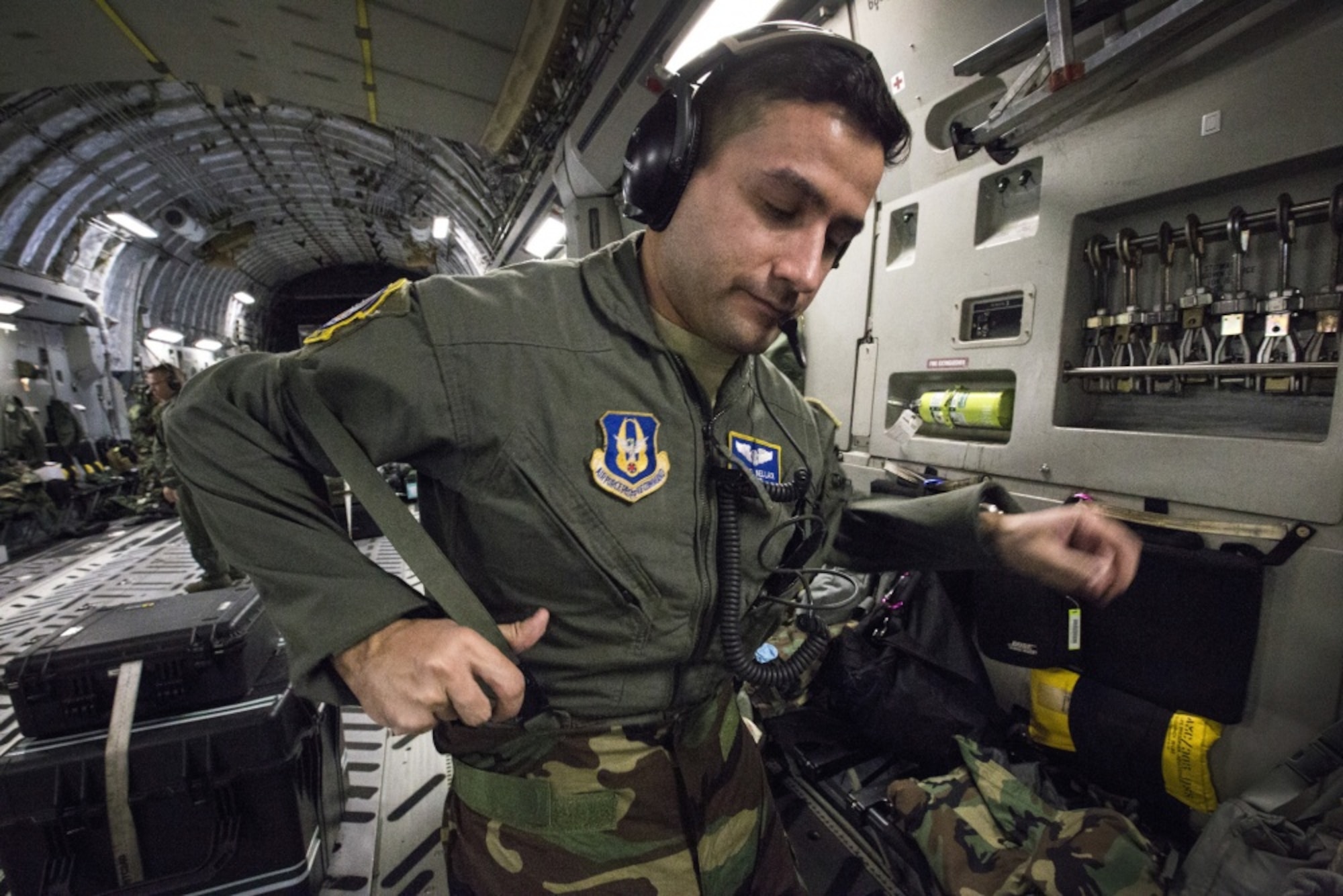 U.S. Air Force Tech. Sgt. Michael Bellack, an aeromedical evacuation technician with the 514th Aeromedical Evacuation (AE) Squadron, puts on his mission oriented protective posture gear during a joint training mission on a C-17 Globemaster III. As AE capabilities continue to evolve, teams continue to train to maintain their skills and be prepared for more challenging patient evacuations. (U.S. Air Force photo by Master Sgt. Mark C. Olsen)