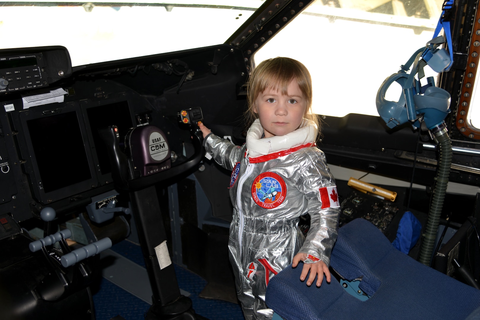 Ready for flight, 3-year-old, Victoria from British Columbia, stands inside of the 433rd Airlift Wing’s  C-5M Super Galaxy aircraft, during the Abbotsford International Airport in Abbotsford British Columbia, Canada to celebrate a week of International Women’s Day, March 10-11, 2018 during the “Sky’s the limit-Girls fly too,” Airshow. (U.S. Air Force photo by Ms. Minnie Jones)