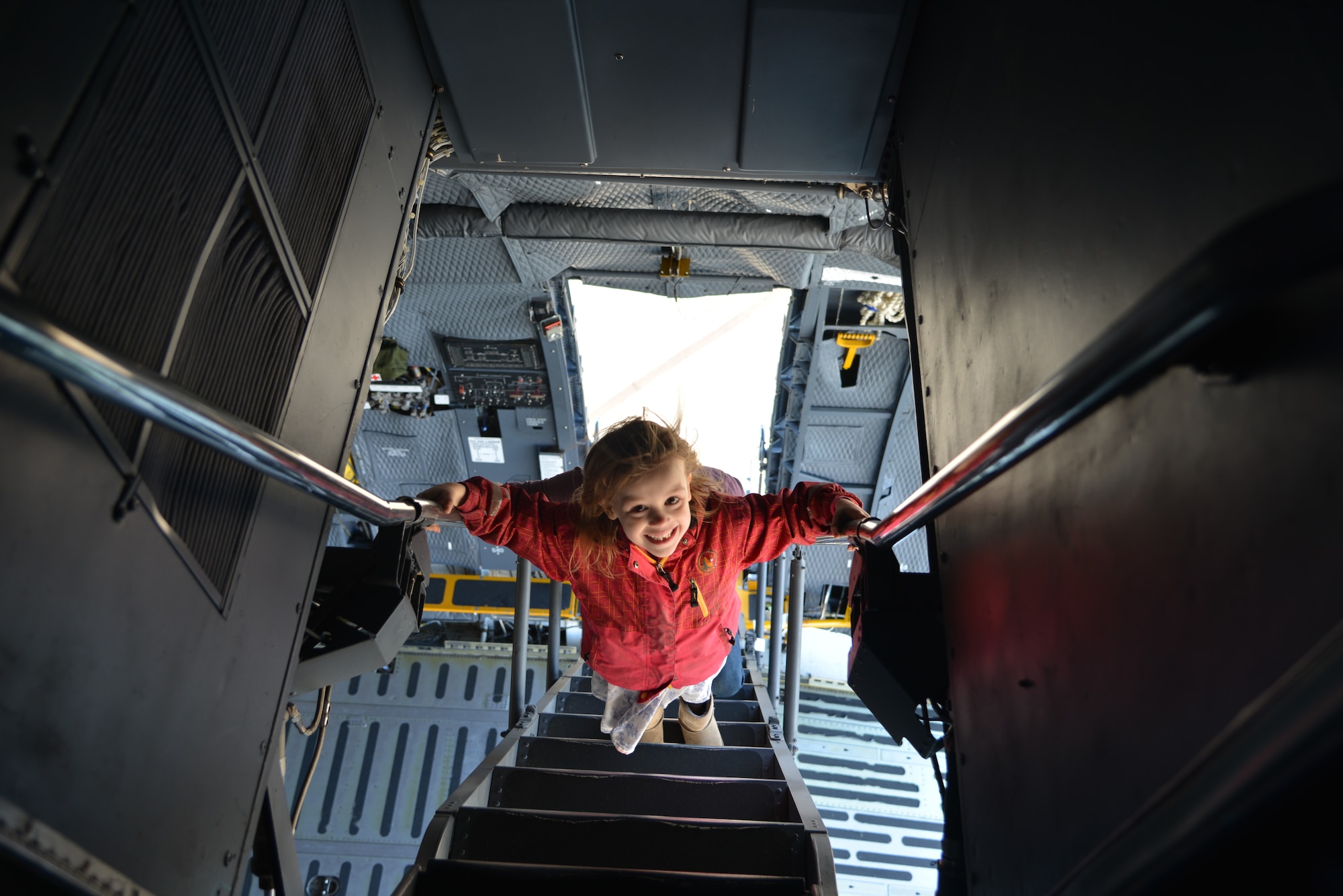 Six-year-old Vivian, boldly climbs the C-5M Super Galaxy’s ladder up to the cockpit, during the Sky’s the limit-Girls fly too” Airshow at the Abbotsford International Airport’s in British Columbia, Canada. The airport celebrated a week of International Women’s Day, March 10-11, 2018. (U.S. Air Force photo by Ms. Minnie Jones)