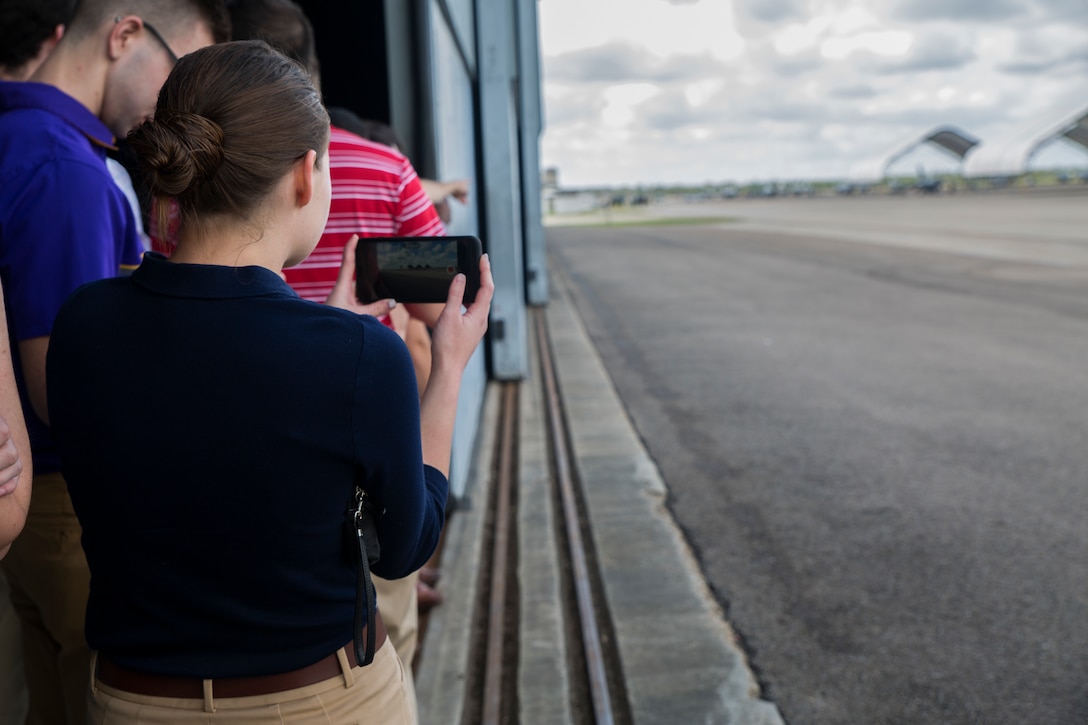 Officer Candidate School applicants and candidates from the local Louisiana area wait on the flight line at Marine Light Attack Helicopter Squadron 773, Marine Aircraft Group 49, 4th Marine Aircraft Wing, as they prepare to watch aircraft depart, March 10, 2018, New Orleans. The candidates had the opportunity to view the aircraft at the squadron, talk with the pilots and learn about career opportunities in the Marine Corps. (U.S. Marine Corps photo by Sgt. Melissa Martens)