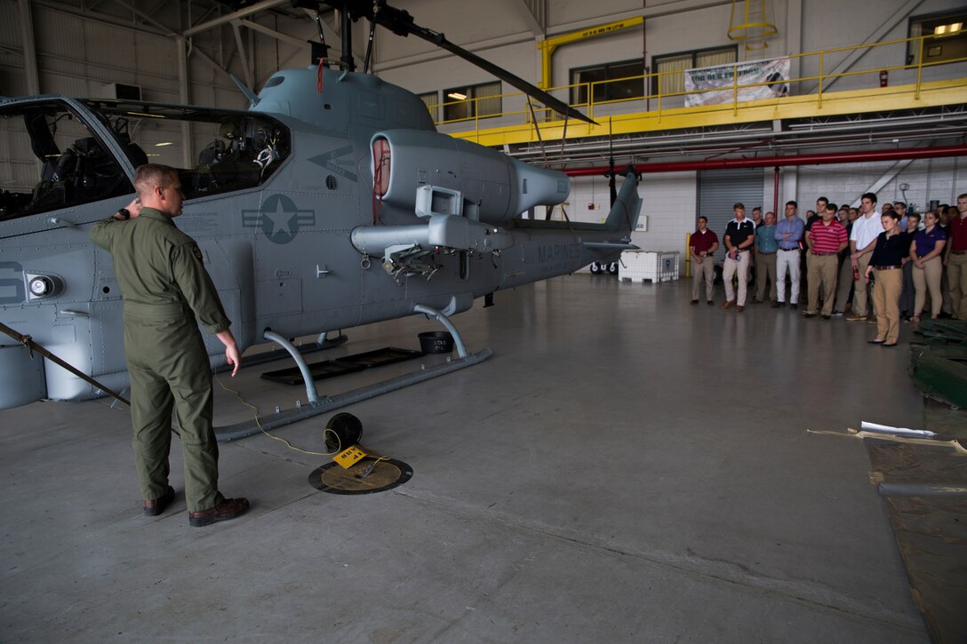 Maj. Christopher J. Cayere, assistant operations officer, Marine Light Attack Helicopter Squadron 773, Marine Aircraft Group 49, 4th Marine Aircraft Wing, explains the functions of a AH-1W Super Cobra helicopter to Officer Candidate School applicants and candidates during a tour of the squadron, March 10, 2018, New Orleans. The candidates had the opportunity to view the aircraft at the squadron, talk with the pilots and learn about career opportunities in the Marine Corps. (U.S. Marine Corps photo by Sgt. Melissa Martens)