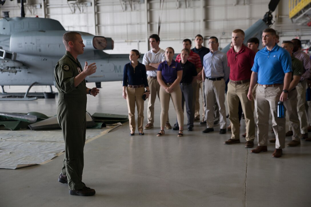 Maj. Christopher J. Cayere, assistant operations officer, Marine Light Attack Helicopter Squadron 773, Marine Aircraft Group 49, 4th Marine Aircraft Wing, goes over different aircraft the squadron operates with Officer Candidate School applicants and candidates from the local Louisiana area, New Orleans, March 10, 2018. The candidates had the opportunity to view the aircraft at the squadron, talk with the pilots and learn about career opportunities in the Marine Corps. (U.S. Marine Corps photo by Sgt. Melissa Martens)