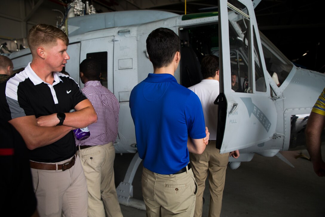 Officer Candidate School applicants and candidates from the local Louisiana area view the aircraft at Marine Light Attack Helicopter Squadron 773, Marine Aircraft Group 49, 4th Marine Aircraft Wing, during a tour of the squadron, March 10, 2018, New Orleans. The candidates had the opportunity to talk with the pilots and learn about career opportunities in the Marine Corps. (U.S. Marine Corps photo by Sgt. Melissa Martens)