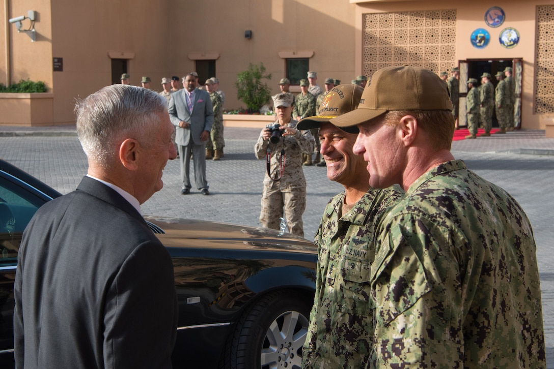 Defense Secretary James N. Mattis talks to two service members.