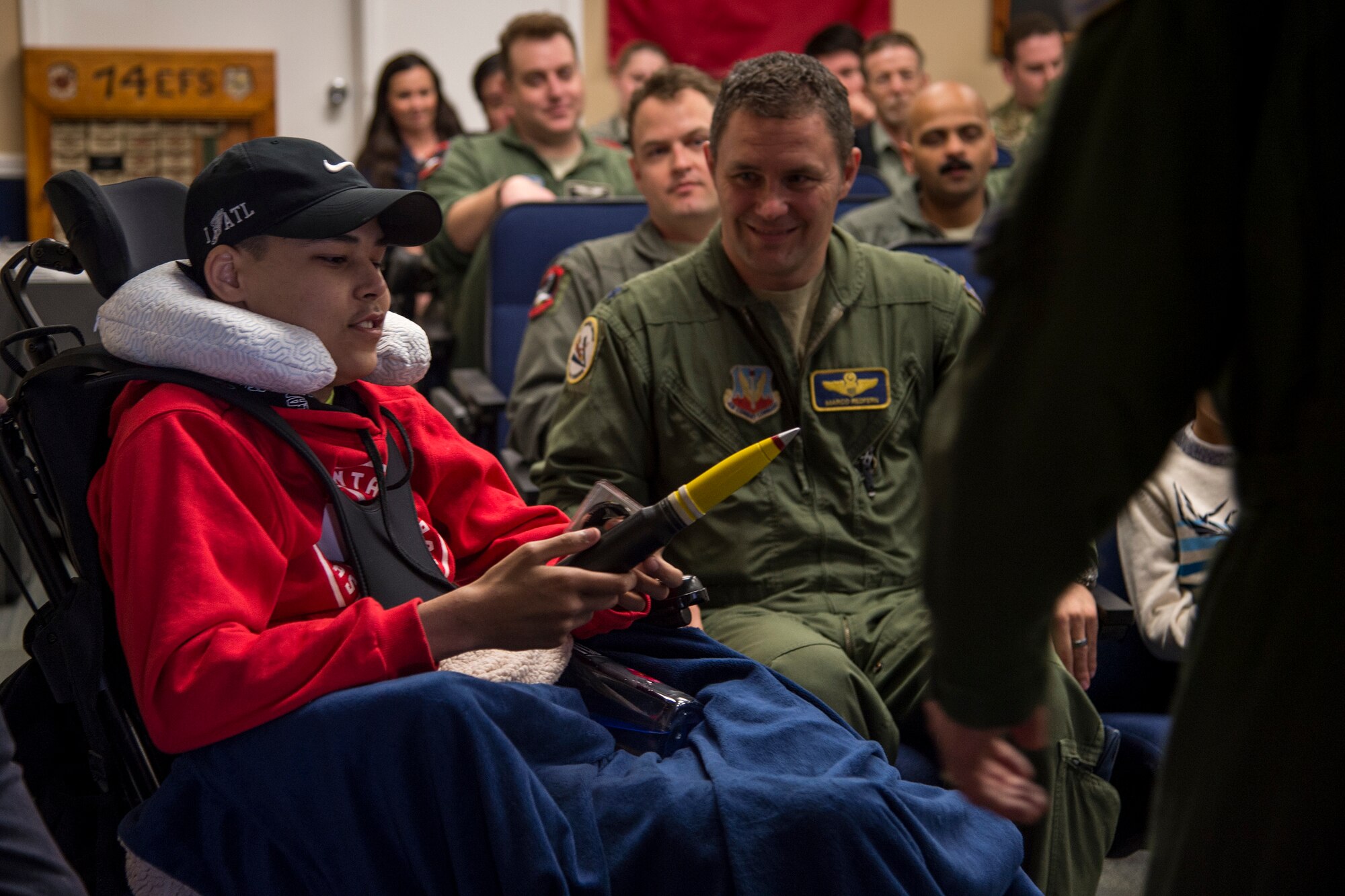 Jarod Story admires a 30 mm shell casing given to him by members of the 74th Fighter Squadron, March 14, 2018, at Moody Air Force Base, Ga. Pilots from the 23d Fighter Group made Storey, who is terminally ill with Osteosarcoma, a rare form of bone cancer, an honorary A-10C Thunderbolt II pilot for a day. (U.S. Air Force photo by Andrea Jenkins)