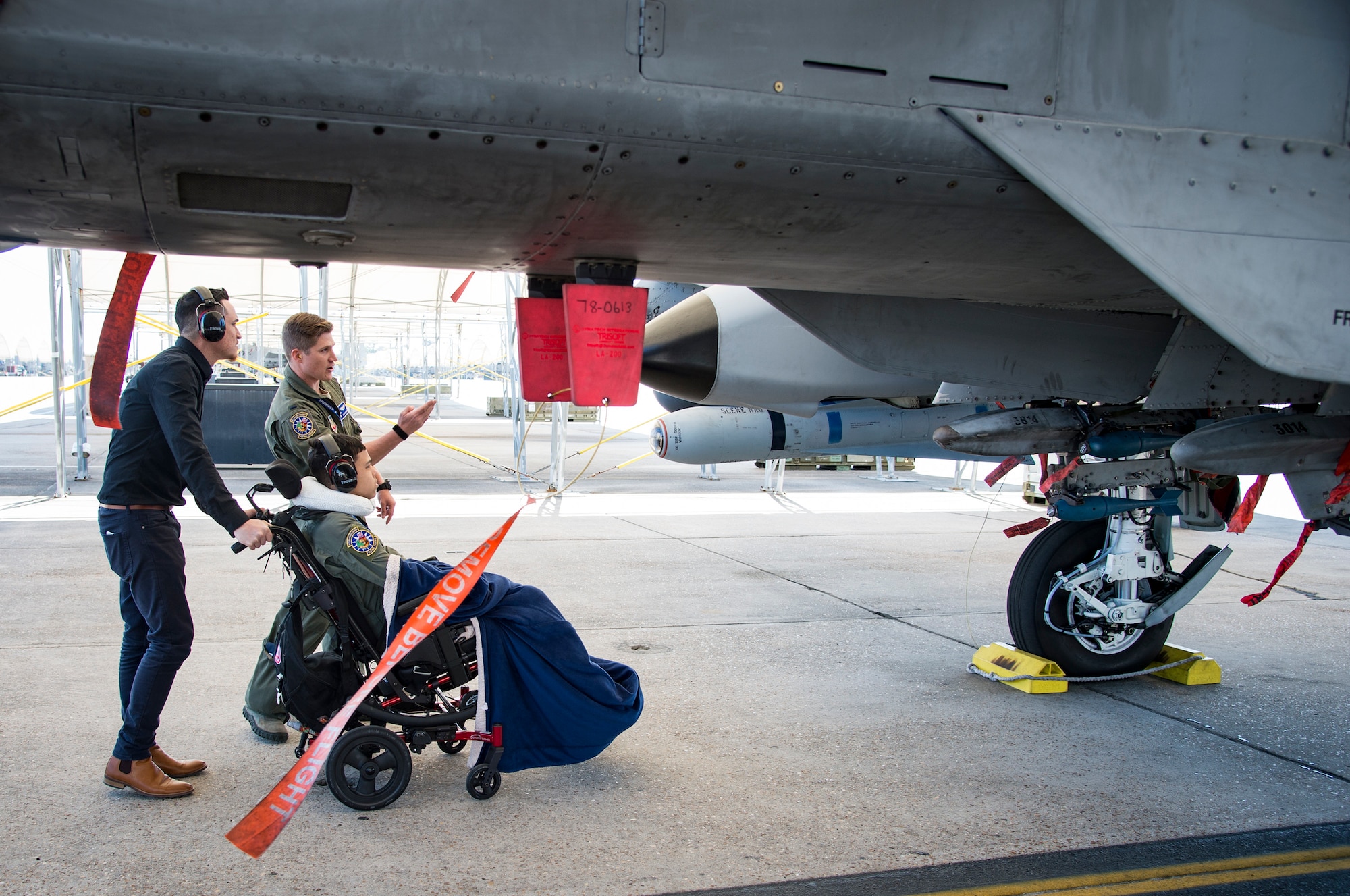 1st Lt. Shaun Dickinson, 74th Fighter Squadron A-10C Thunderbolt II pilot, gives 15-year-old Jarod Story a tour of the flightline, March 14, 2018, at Moody Air Force Base, Ga. Pilots from the 23d Fighter Group made Storey, who is terminally ill with Osteosarcoma, a rare form of bone cancer, an honorary A-10 pilot for a day. (U.S. Air Force photo by Andrea Jenkins)