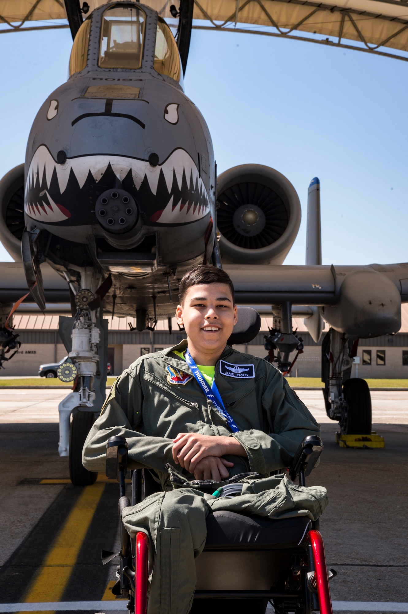 Jared Storey poses for a photo in front of an A-10C Thunderbolt II on the flightline, March 14, 2018, at Moody Air Force Base, Ga. Pilots from the 23d Fighter Group made Storey, who is terminally ill with Osteosarcoma, a rare form of bone cancer, an honorary A-10 pilot for a day. (U.S. Air Force photo by Andrea Jenkins)