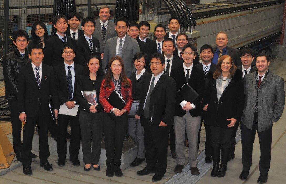 IMAGE: DAHLGREN, Va. - Twenty members of the Japanese Ministry of Defense and Self-Defense Forces delegation representing Japan's Ground, Maritime and Air Self-Defense Forces (GSDF, MSDF, and ASDF) are pictured with three representatives of the U.S. Center for Strategic and International Studies and two Naval Surface Warfare Center Dahlgren Division (NSWCDD) leaders - Chester Petry, electromagnetic railgun lead systems engineer, and Jed Ryan, International Partnering Office lead - in front of the electromagnetic railgun prototype launcher. Navy scientists and engineers briefed the Japanese delegation on NSWCDD mission and capabilities, focusing on directed energy weapons, electromagnetic railgun, hypervelocity projectile, and human systems integration programs. The February visit is the latest in a series of annual visits supporting the U.S. Center for Strategic and International Studies and Japan's Ministry of Defense Executive Training Program. The Japanese Ministry of Defense and Self-Defense Forces carry out various activities seamlessly and flexibly based on joint operations of GSDF, MSDF, and ASDF.  (U.S. Navy photo/Released)
